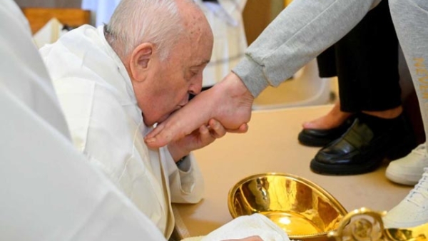 Pope Francis kisses the foot of an inmate after washing it during the Holy Thursday Mass of the Lord's Supper at the Rebibbia women's prison on the outskirts of Rome March 28, 2024. 