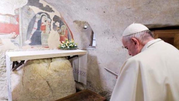 Pope Francis prays during a visit to the Chapel of the Nativity
